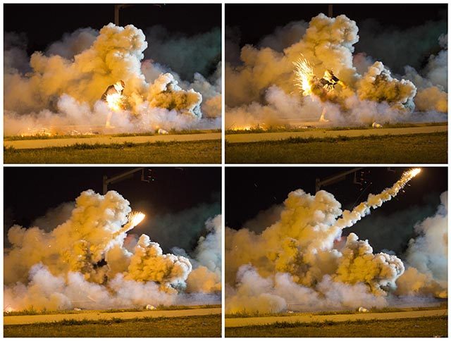 Combination photograph shows in sequence a protester throwing back a smoke bomb while clashing with police in Ferguson, Missouri