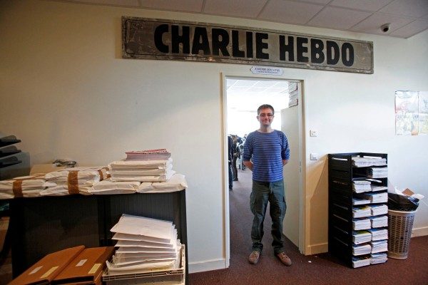 File photo of French cartoonist Charb, publishing director of French satirical weekly Charlie Hebdo, posing for photographs at their offices in Paris