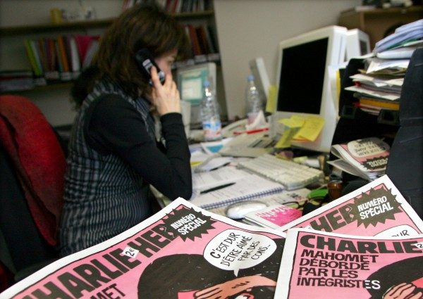 File photo of a journalist working in the Paris newsroom of French satirical weekly Charlie Hebdo