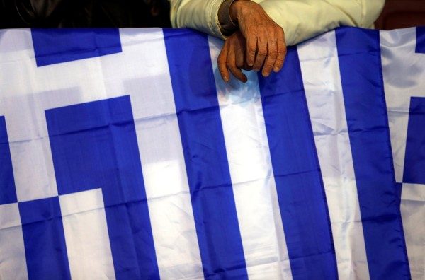 A conservative supporter waits before a campaign rally by Greek Prime Minister and leader of the conservative New Democracy party Antonis Samaras in Athens