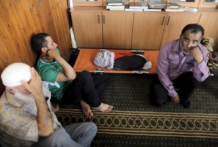 Mourners react next to the body of 18-month-old Palestinian baby Ali Dawabsheh, who was killed after his family's house was set to fire in a suspected attack by Jewish extremists in Duma village near Nablus