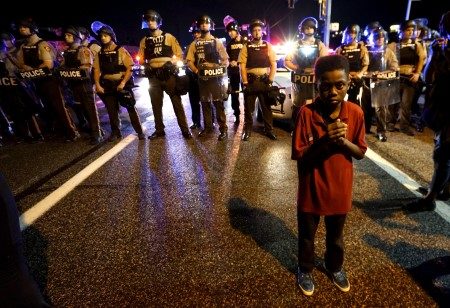 Amarion Allen, 11-years-old stands in front of a police line shortly before shots were fired in a police-officer involved shooting in Ferguson