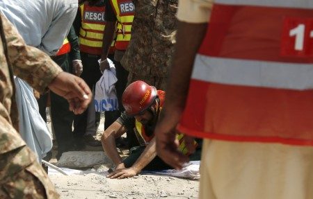 Rescue workers search for survivors after a blast near the home of the home minister of Punjab province, Shuja Khanzada, in Attock