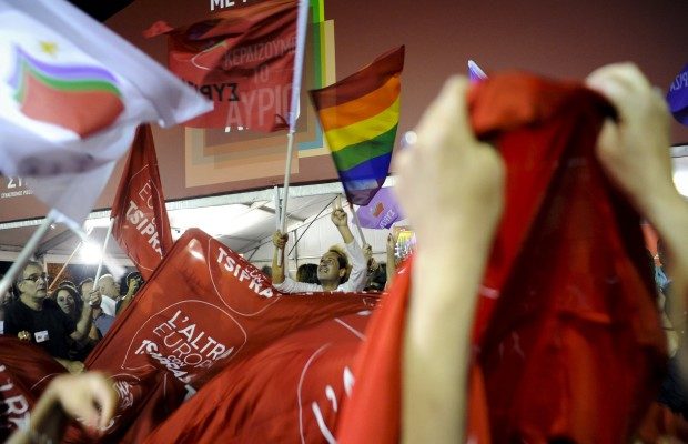 Supporters of leftist Syriza party react at the party's main election kiosk after seeing early results following a general election in Athens
