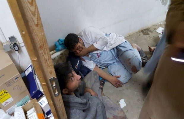 Afghan staff react inside a Medecins Sans Frontieres (MSF) hospital after an air strike in the city of Kunduz, Afghanistan