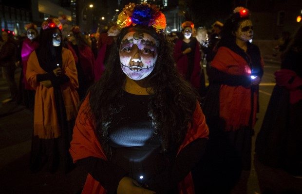 A woman dressed in a "Dia de Muertos" or "Day of the Dead" theme participates in the Greenwich Village Halloween Parade in Manhattan