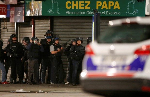French police secure the area during an operation to catch Paris attack fugitives in Saint-Denis