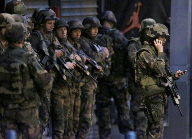 French soldiers secure the area during an operation to catch Paris attack fugitives in Saint-Denis