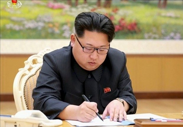 North Korean leader Kim Jong Un signs on a document regarding test of a hydrogen bomb in this still image taken from KRT and released by Yonhap