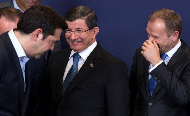Greek Prime Minister Tsipras, Turkish Prime Minister Davutoglu and European Council President Tusk attend a group photo during a EU-Turkey summit in Brussels