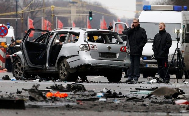 Police inspect a damaged Volkswagen car in the Bismarckstrasse in Berlin