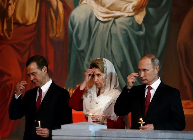Russian President Vladimir Putin (R), Prime Minister Dmitry Medvedev and his wife Svetlana, pray during an Orthodox Easter service at the Christ the Saviour Cathedral in Moscow, Russia, May 1, 2016. REUTERS/Sergei Karpukhin