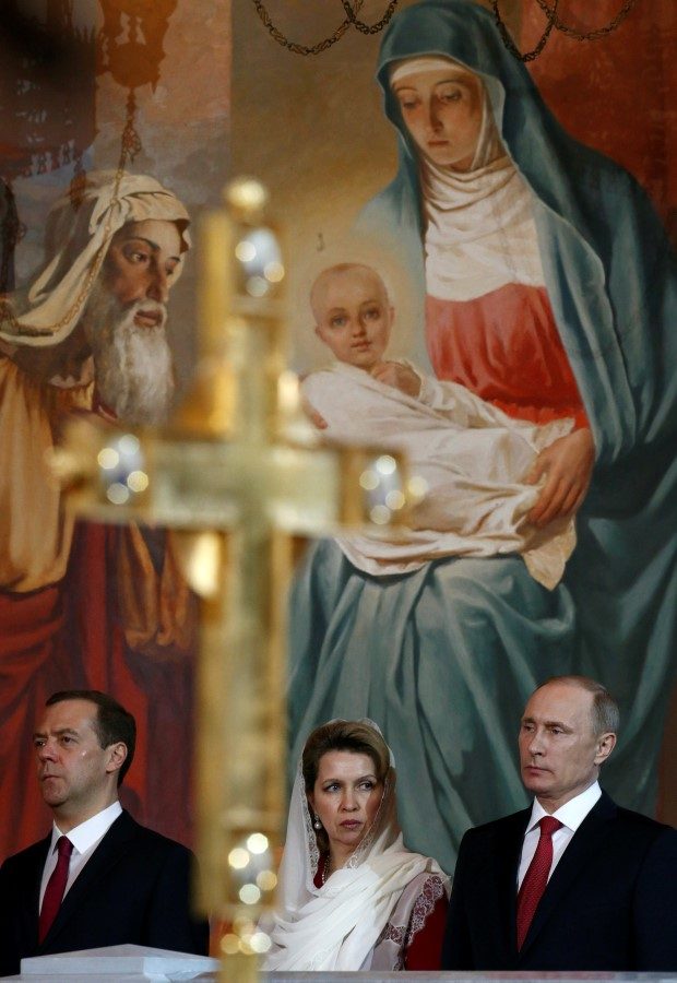 Russian President Vladimir Putin (R), Prime Minister Dmitry Medvedev and his wife Svetlana, attend an Orthodox Easter service at the Christ the Saviour Cathedral in Moscow, Russia, May 1, 2016. REUTERS/Sergei Karpukhin