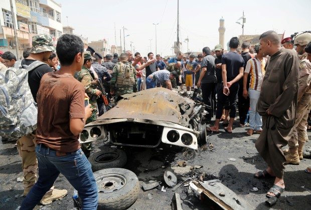 People gather at the scene of a car bomb attack in Baghdad's mainly Shi'ite district of Sadr City, Iraq, May 11, 2016. REUTERS/Wissm al-Okili